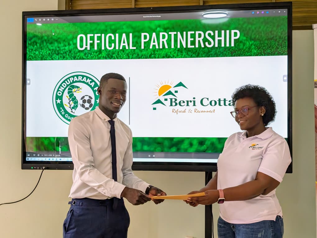 Owen Ezaga and Managing Director Beri cottage exchanging documents of the partnership